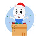 Kitten in a Christmas hat with a box of Christmas decorations